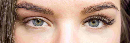 A woman’s eyes with eyelash extensions on the right side