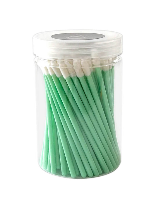 Green lip wand applicators in clear jar from Yegi Beauty for eyelash extension artists.