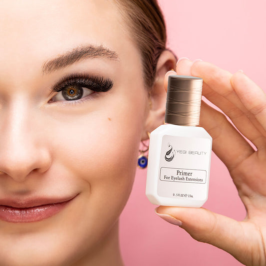 15ml white bottle with gold cap and pink label. Label reads "Yegi Beauty Primer For Eyelash Extensions" in black letters. Bottle being held by smiling woman in left hand with pink background.  Woman sporting eyelash extensions