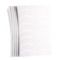 Stack of sheets displaying eyelash mapping stickers for lash techs.