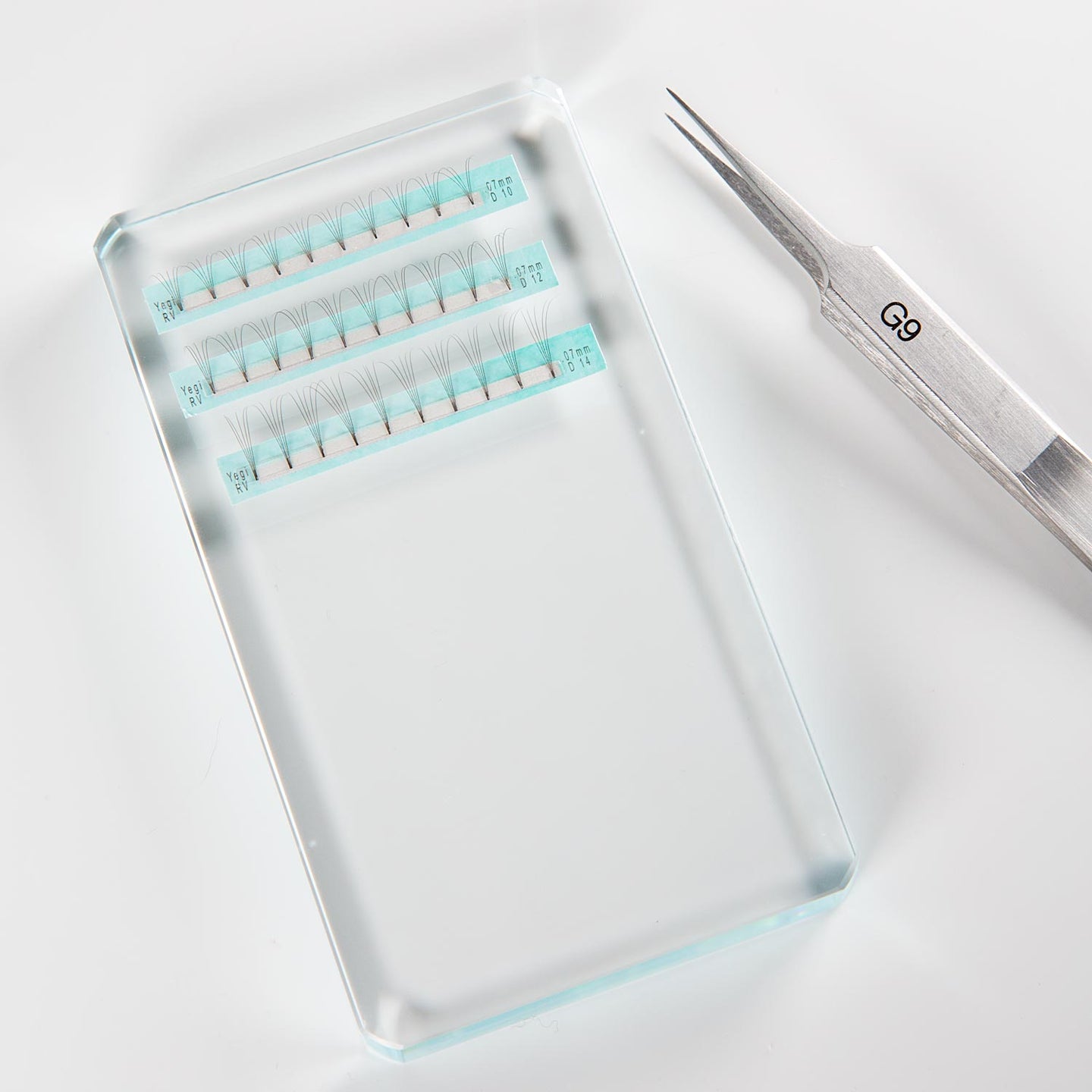 Glass eyelash holder with extensions and tweezer 