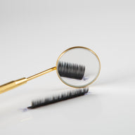 Eyelash mirror with ruler showing eyelash extensions in reflection
